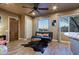 Comfortable living room featuring tile floors, an entertainment center, and picturesque outdoor views at 13935 E Smokehouse Trl, Scottsdale, AZ 85262