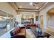 Open living space showing the kitchen and breakfast bar, a fireplace, sliding doors and tray ceilings at 13935 E Smokehouse Trl, Scottsdale, AZ 85262