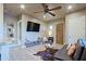 Cozy living room featuring modern decor, a stylish ceiling fan, and a comfortable leather sofa at 13935 E Smokehouse Trl, Scottsdale, AZ 85262