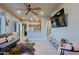 Bright, open-concept living room with modern furnishings and tile flooring seamlessly connects to the kitchen at 13935 E Smokehouse Trl, Scottsdale, AZ 85262