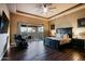 Spacious main bedroom with tray ceiling, dark furniture, and outdoor access at 13935 E Smokehouse Trl, Scottsdale, AZ 85262