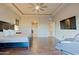 Large main bedroom with hardwood floors, a tray ceiling, and a comfortable seating area at 13935 E Smokehouse Trl, Scottsdale, AZ 85262