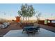 Outdoor dining space with metal table and chairs, windmill, and views of the desert landscape at 13935 E Smokehouse Trl, Scottsdale, AZ 85262