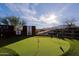 Enjoy outdoor living on this large putting green with colorful murals and desert landscape in this backyard at 13935 E Smokehouse Trl, Scottsdale, AZ 85262