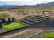 Landscaped putting green with tiered planters, desert vegetation, and custom shade structure for outdoor recreation at 13935 E Smokehouse Trl, Scottsdale, AZ 85262