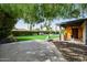 View of backyard with artificial grass, a basketball hoop, covered patio, and sparkling swimming pool at 1755 W Lawrence Ln, Phoenix, AZ 85021