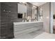 Bathroom features a double sink vanity with sleek gray cabinetry and modern tiled walls at 1755 W Lawrence Ln, Phoenix, AZ 85021