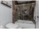 Bathroom features a glass-enclosed shower with marbled tile and modern toilet at 1755 W Lawrence Ln, Phoenix, AZ 85021