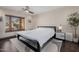 Bedroom boasts neutral walls, ceiling fan and light colored rug and natural light at 1755 W Lawrence Ln, Phoenix, AZ 85021