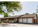 Single-story home featuring a two-car garage and desert landscaping at 1755 W Lawrence Ln, Phoenix, AZ 85021