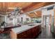 Open kitchen featuring an island with bar seating, custom cabinetry, and stainless steel appliances at 1755 W Lawrence Ln, Phoenix, AZ 85021