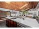 Spacious kitchen features marble countertops, stainless steel appliances, and a unique wooden ceiling at 1755 W Lawrence Ln, Phoenix, AZ 85021