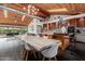 Open-concept living area with a wood ceiling, dining area, and modern kitchen featuring an island at 1755 W Lawrence Ln, Phoenix, AZ 85021