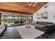 Bright living room with a wood ceiling, tile floors, and sliding glass doors to the patio and pool at 1755 W Lawrence Ln, Phoenix, AZ 85021