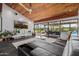 Open living area featuring a wood ceiling, tile floors, modern furnishings, and views of outdoor pool at 1755 W Lawrence Ln, Phoenix, AZ 85021