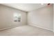 A carpeted bedroom featuring a neutral color palette and plenty of natural light at 17842 W Getty Dr, Goodyear, AZ 85338