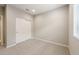 Bedroom featuring carpet flooring, large window and closet at 17842 W Getty Dr, Goodyear, AZ 85338