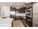 Close up of stainless steel appliances and dark cabinets in a modern kitchen at 17842 W Getty Dr, Goodyear, AZ 85338