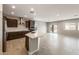 Open-concept kitchen featuring stainless steel appliances, a center island, and tile flooring at 17842 W Getty Dr, Goodyear, AZ 85338