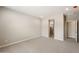 Spacious bedroom featuring carpeted floors, neutral walls, and doorways leading to a walk-in shower and closet at 17842 W Getty Dr, Goodyear, AZ 85338