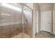 Modern glass enclosed shower with gray tile surround and tiled shower floor at 17842 W Getty Dr, Goodyear, AZ 85338