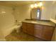 Well-lit bathroom featuring a vanity, mirror, granite counters, and tiled shower at 200 E Southern Ave # 348, Tempe, AZ 85282