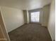 Bedroom with neutral-colored walls, carpeted floors, and a large window at 200 E Southern Ave # 348, Tempe, AZ 85282