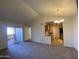 Spacious living room with balcony access and a view into the kitchen at 200 E Southern Ave # 348, Tempe, AZ 85282