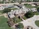 A large brick estate with well manicured lawns, a barn, mature trees, and fencing at 2025 S Val Vista Dr, Gilbert, AZ 85295