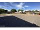 Gravel backyard featuring RV parking, mature trees, fence, and blue skies at 2025 S Val Vista Dr, Gilbert, AZ 85295