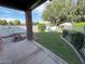 Spacious backyard featuring lush green grass, a white fence, and a covered patio area for outdoor entertaining at 2025 S Val Vista Dr, Gilbert, AZ 85295