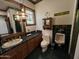 Bathroom with vanity sink, toilet, and urinal with stained glass window and decor at 2025 S Val Vista Dr, Gilbert, AZ 85295