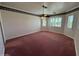 Spacious bedroom with three windows fitted with shutters, ceiling fan, and rose-colored carpeting at 2025 S Val Vista Dr, Gilbert, AZ 85295