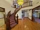 Grand foyer featuring hardwood floors, a curved staircase, and a decorative light fixture at 2025 S Val Vista Dr, Gilbert, AZ 85295