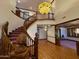 Grand foyer with a curved staircase, wood flooring, and decorative chandelier at 2025 S Val Vista Dr, Gilbert, AZ 85295