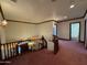 An interior hallway with stairs, pink carpet, wooden trim, and a stained-glass window accent at 2025 S Val Vista Dr, Gilbert, AZ 85295