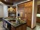 Kitchen island with granite countertops and cooktop, surrounded by wood cabinets at 2025 S Val Vista Dr, Gilbert, AZ 85295