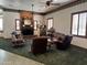 Living room featuring a brick fireplace with TV, stained glass windows, and ceiling fans at 2025 S Val Vista Dr, Gilbert, AZ 85295