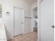 Hallway bathroom featuring white cabinets, tile flooring, and neutral paint at 20840 E Vía Del Palo --, Queen Creek, AZ 85142