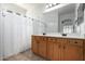 Bathroom with dual sinks, wooden cabinets and tiled floor at 20840 E Vía Del Palo --, Queen Creek, AZ 85142