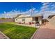 Outdoor living space featuring a cozy seating area, grill, and a well-manicured lawn at 2301 E Alpine E Ave, Mesa, AZ 85204