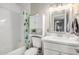 Bright bathroom with a white vanity, framed mirror, subway tile and a shower-tub combo at 2301 E Alpine E Ave, Mesa, AZ 85204