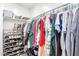 Walk-in closet featuring ample storage with shelving, hanging rods, and shoe racks for organization at 2301 E Alpine E Ave, Mesa, AZ 85204