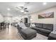 Open-concept living room flows into kitchen, featuring a gray sectional sofa and neutral decor at 2301 E Alpine E Ave, Mesa, AZ 85204