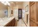 Well-lit bathroom featuring a vanity with sink, toilet, and a decorative mirror and paintings at 2430 S Geronimo Head Trl, Gold Canyon, AZ 85118