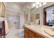 Bright bathroom featuring a bathtub with shower, vanity with sink, and a large mirror at 2430 S Geronimo Head Trl, Gold Canyon, AZ 85118