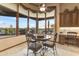 Cozy breakfast nook features large windows with expansive views, a ceiling fan, and built-in cabinets at 2430 S Geronimo Head Trl, Gold Canyon, AZ 85118