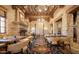 Cozy dining room featuring stone walls, a fireplace, and comfortable seating at 2430 S Geronimo Head Trl, Gold Canyon, AZ 85118