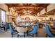 Elegant dining room with wooden beam ceilings, a cozy fireplace, and stylish seating at 2430 S Geronimo Head Trl, Gold Canyon, AZ 85118