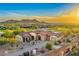 Beautiful desert home featuring a red tile roof, stone accents, spacious driveway, and desert landscaping at 2430 S Geronimo Head Trl, Gold Canyon, AZ 85118